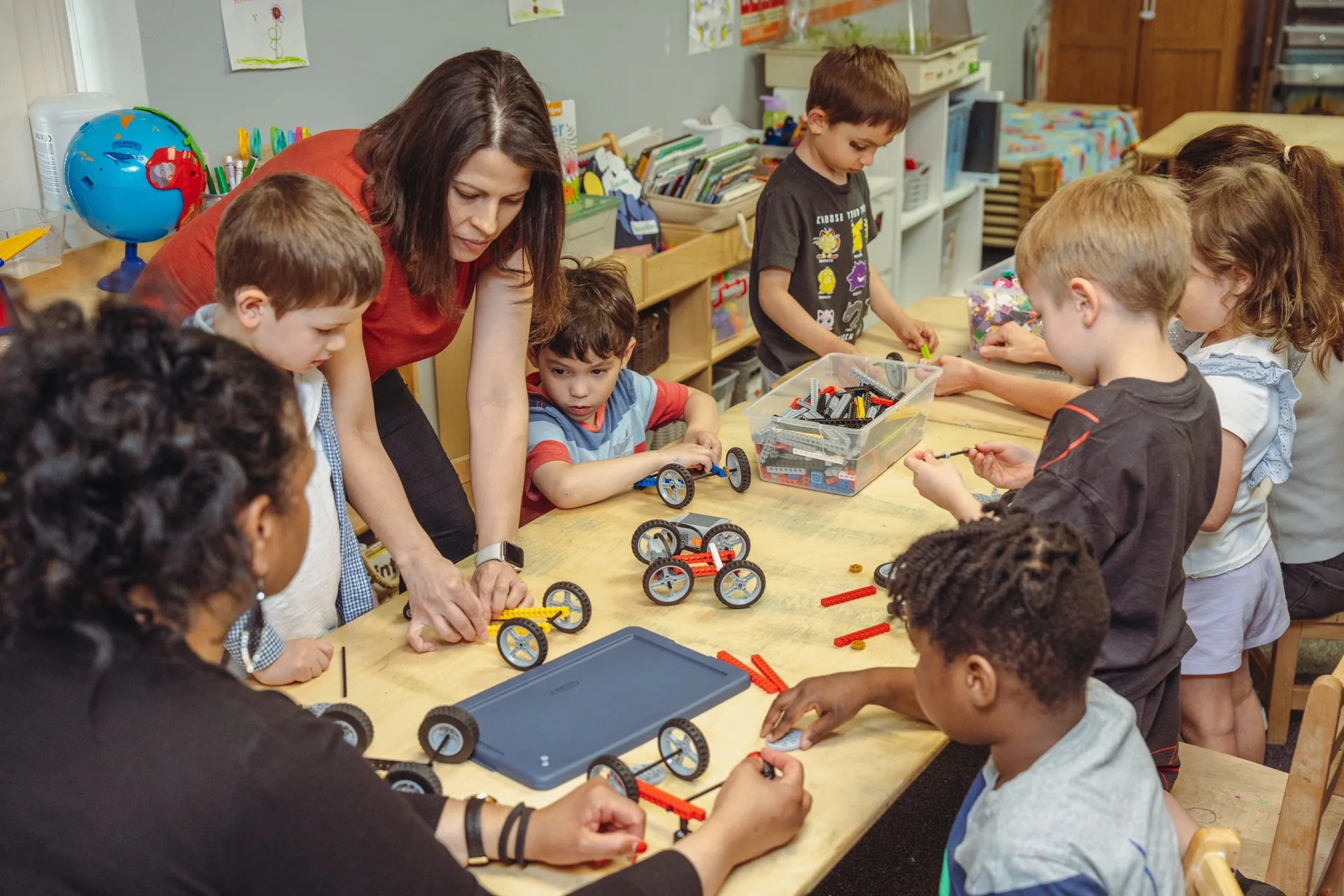 Woburn director guiding children through a hands-on STEM classroom activity